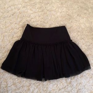 Black skirt. Pencil fitted on top with flowing lower half